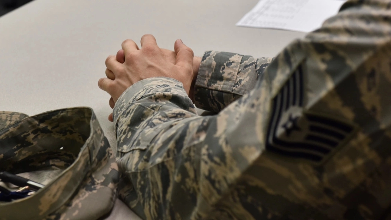 Veteran sitting at a desk getting information during a Veterans Benefits session.