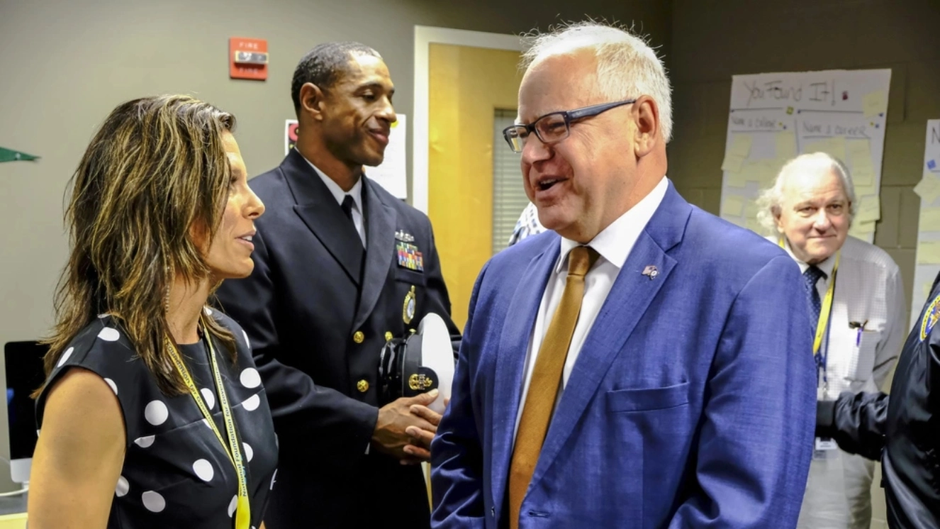 Tim Walz military career as he talks with officials.