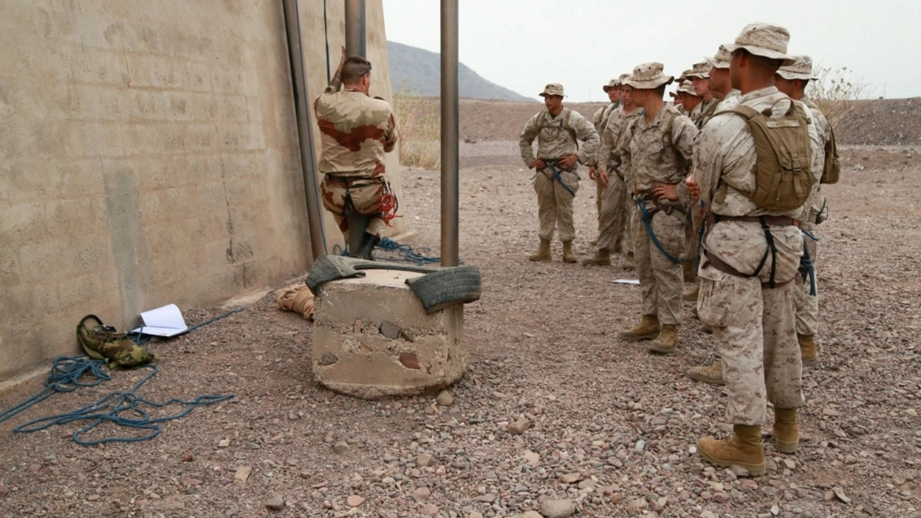 An instructor with the French 5th Overseas Combined Arms Regiment (RIAOM) demonstrates climbing techniques to U.S. Marines with the 15th Marine Expeditionary Unit during a portion of a desert survival course. in light of US military in middle east.