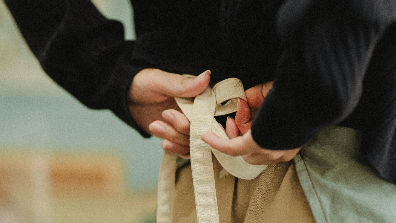 Veteran business owners tying apron.