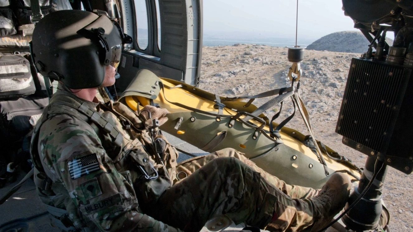 U.S. Army Spc. Trevor Milbury, of Sandwich, N.H., a crew chief with the Medevac Platoon “Army Dustoff,” Company C, 3rd Battalion, 238th Aviation Regiment, Task Force Dragon, pulls a litter on a hoist back into his crew’s UH-60 Black Hawk helicopter during a training exercise near Forward Operating Base Fenty, Nangarhar province, Afghanistan, Sept. 16, 2013.