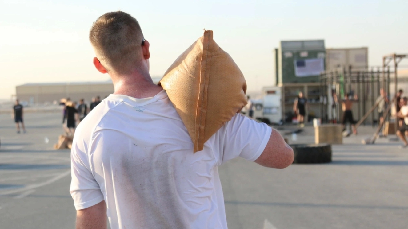 Jack Rozema, Texas native and Intelligence noncommissioned officer in charge with the 69th Air Defense Artillery Brigade, completes the 343 meter sandbag carry during the September 11th Memorial CrossFit workout, Sept. 11. 2016 at Al Udeid Air Base, Qatar.