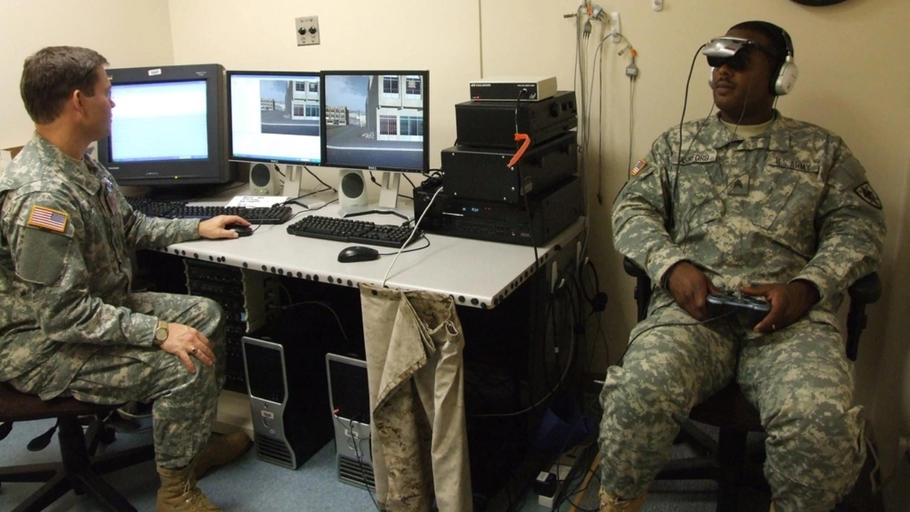 Dr. Michael J. Roy, who oversees the "Virtual Iraq" exposure therapy at Walter Reed Army Medical Center, conducts a demonstration of a life-like virtual reality exposure therapy simulator that represents a new form of post-traumatic stress disorder treatment.