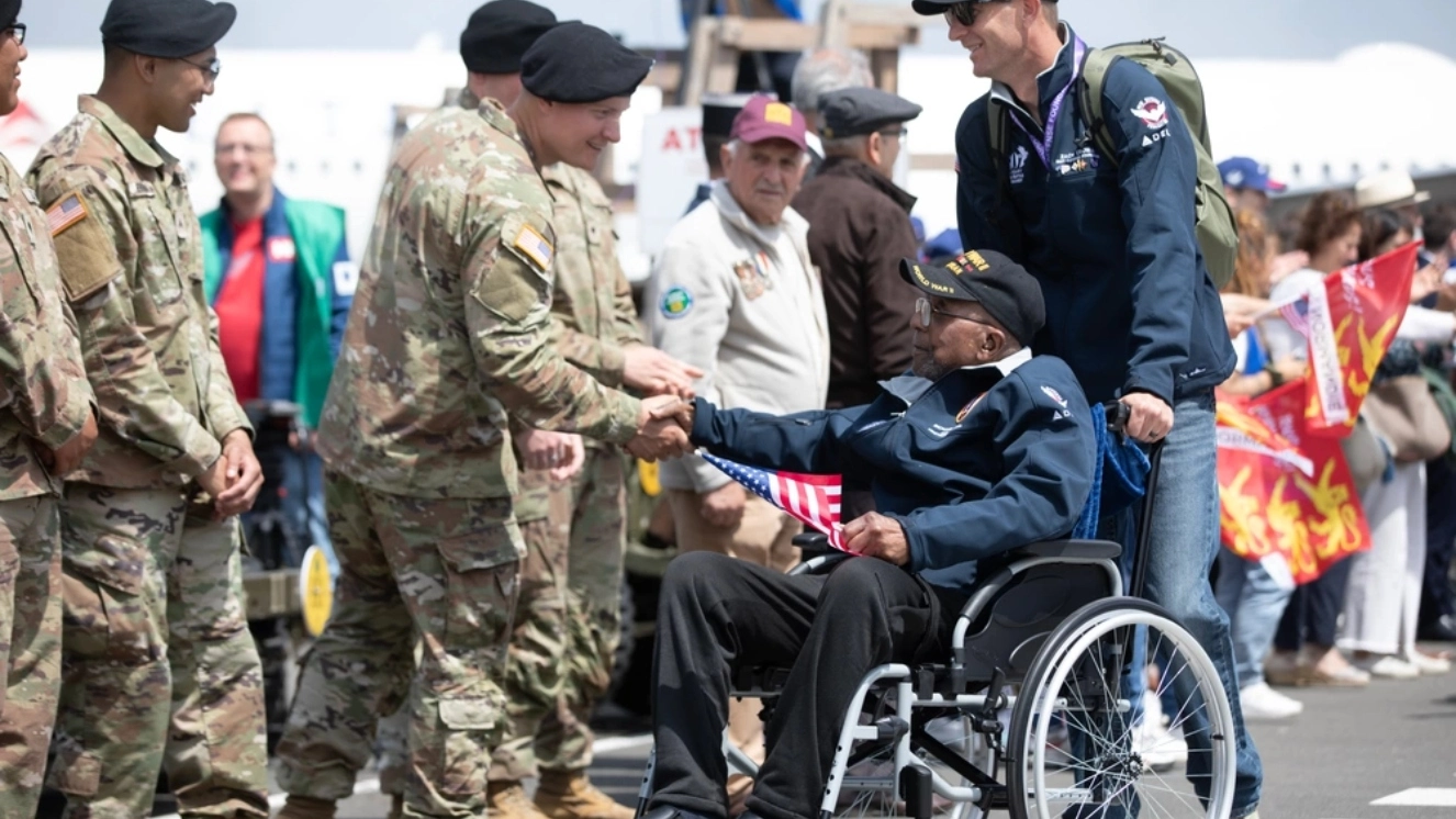 Richard Stewart, a WWII battles veteran, formerly a communications lineman for the 459th Signal Construction Battalion, Air Force, is welcomed by Soldiers from the 4th Infantry Division Deauville-Normandie airport, Deauville, France, June 3, 2024.