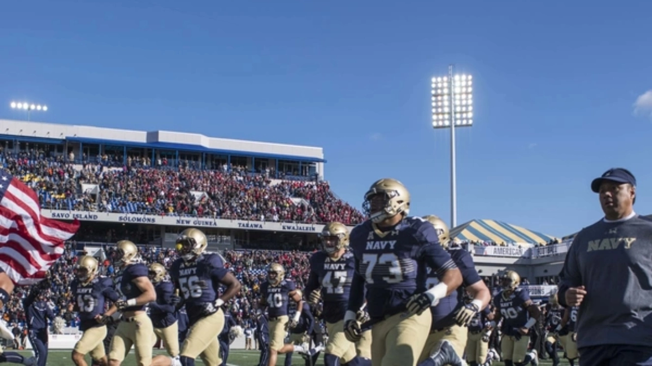 U.S. Naval Academy Midshipmen Head Football Coach Ken Niumatalolo enters the stadium with his team prior to the start of the American Athletic Conference football game.