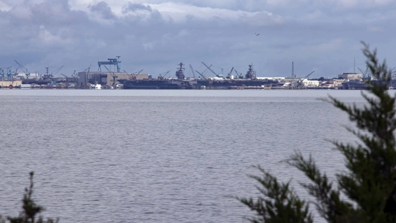 USS Gerald R. Ford (CVN 78) prepares to moor next to Pre-Commissioning Unit John F. Kennedy (CVN 79) following a transit from Naval Station Norfolk to Newport News Shipyard, Virginia, Aug. 20, 2021.