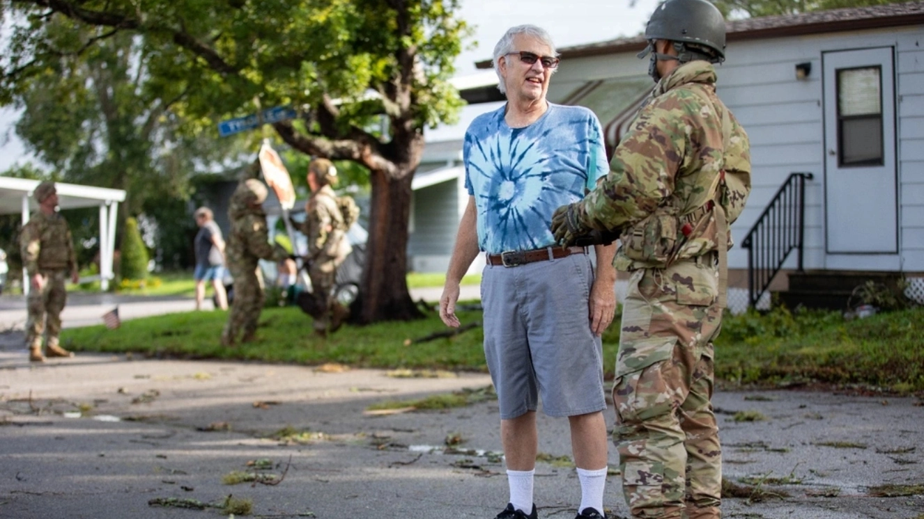 Florida Army National Guard Soldiers with the 3rd Battalion, 116th Field Artillery Regiment, check in with a resident and clear debris and providing VA disaster relief following Hurricane Milton during a Survey and Assist patrol in Kissimmee, Florida, Oct. 10, 2024.